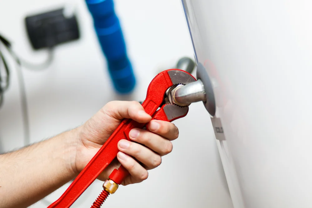 Plumber repairing hot water system